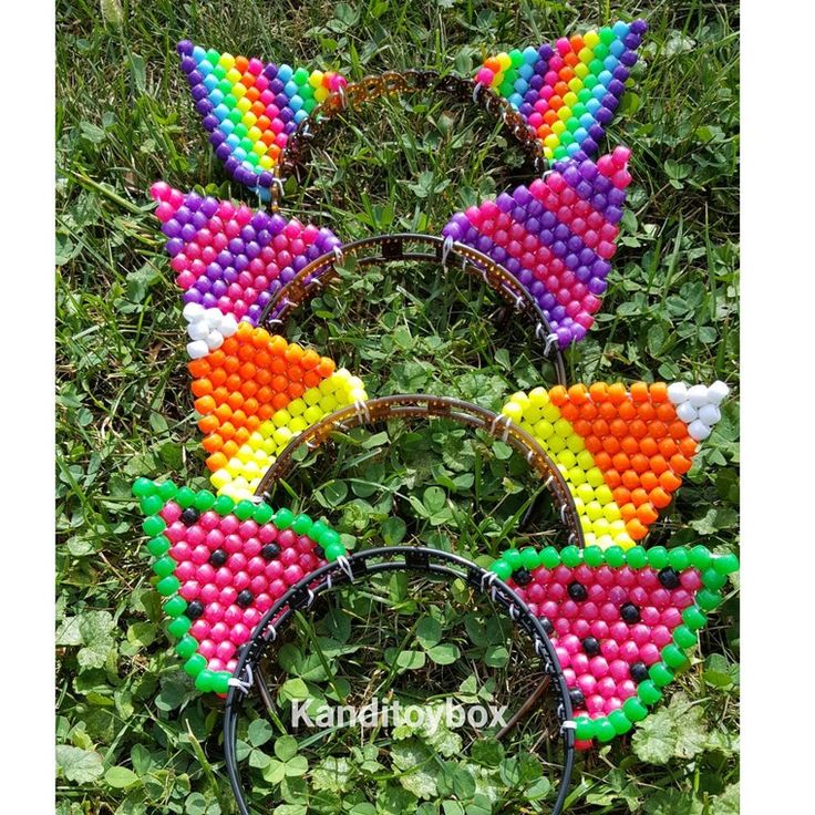 three ears made out of beads are in the grass