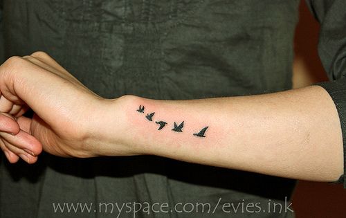 a woman's arm with birds on it and the word love written in black ink