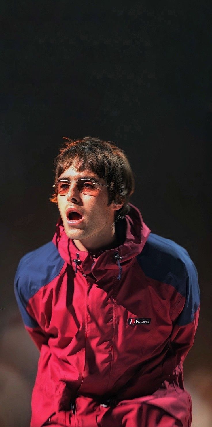 a man in a red and blue jacket with his mouth open