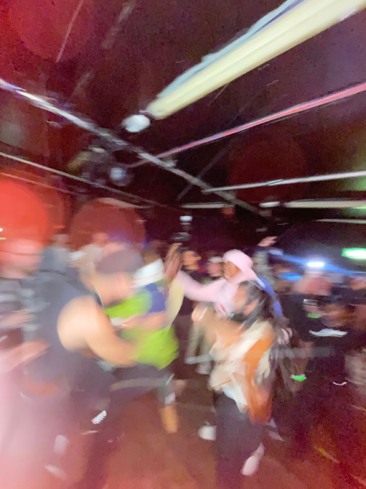 blurry photograph of people dancing in a club