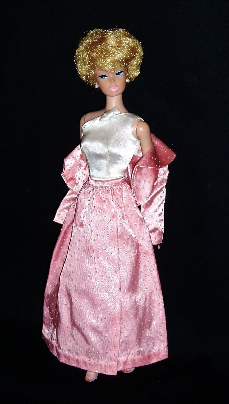 a barbie doll wearing a pink and white dress