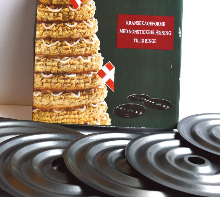 a box of cookies sitting on top of a table next to some metal plates and spoons