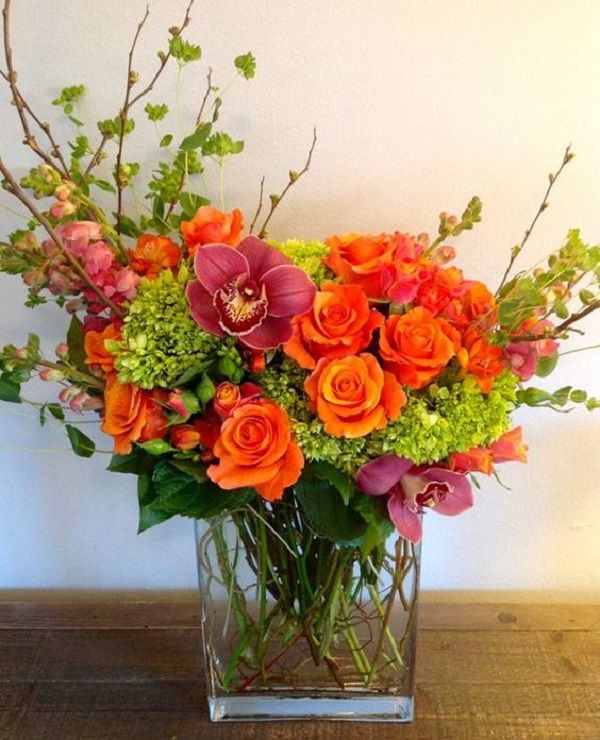 a vase filled with orange and pink flowers