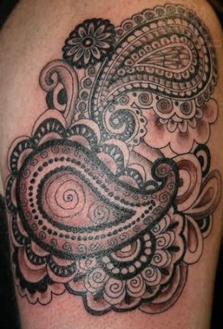 a black and white tattoo on the back of a woman's arm with an intricate design