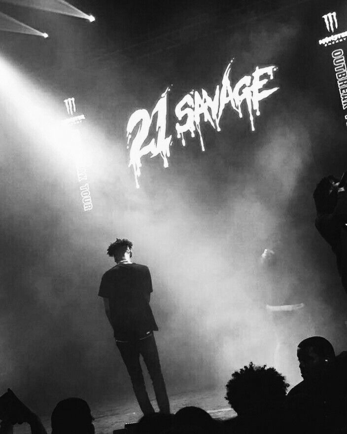 a man standing on top of a stage in front of a crowd