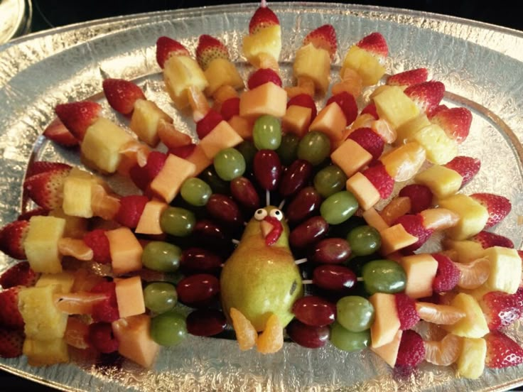 a turkey made out of fruit on a platter