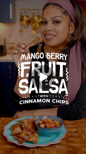 a woman sitting at a table eating food with the words mango berry fruit salsa and cinnamon chips