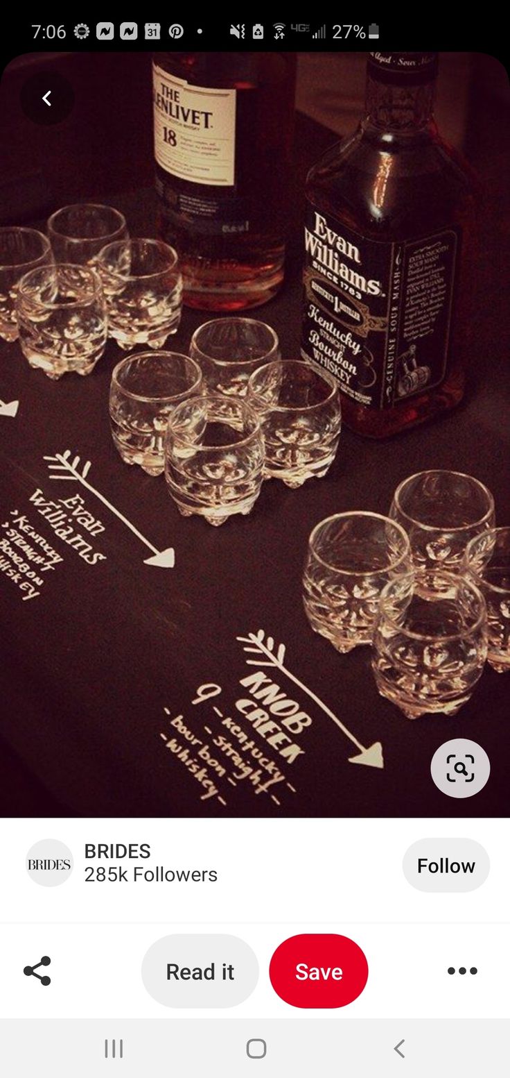 a table topped with lots of glasses next to bottles of alcohol on top of it