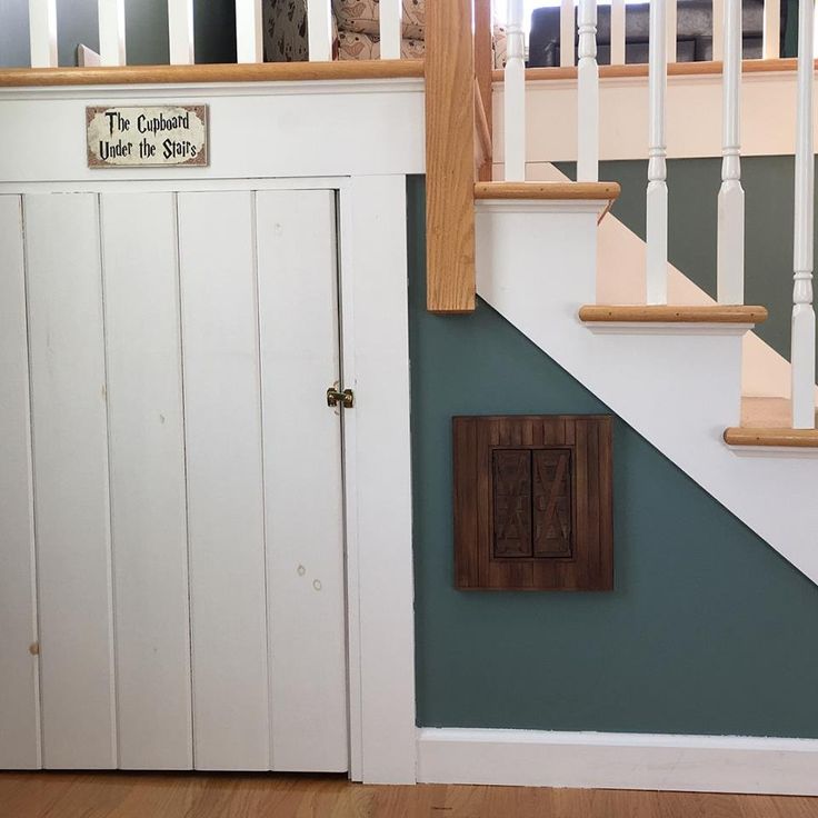 the stairs are painted blue and white with a wooden paneled door on one side