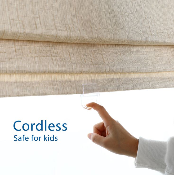 a person holding a glass in front of a window with the words cordless safe for kids