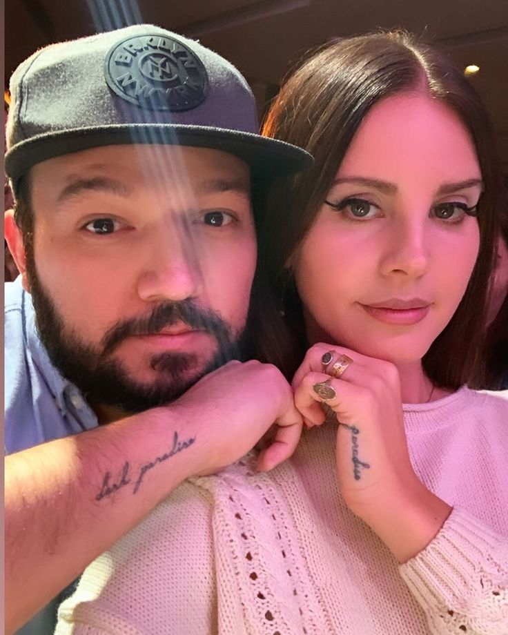 a man and woman with tattoos on their arms