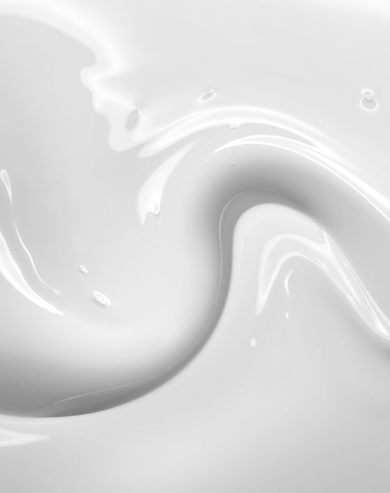 white liquid swirls into the shape of a wave