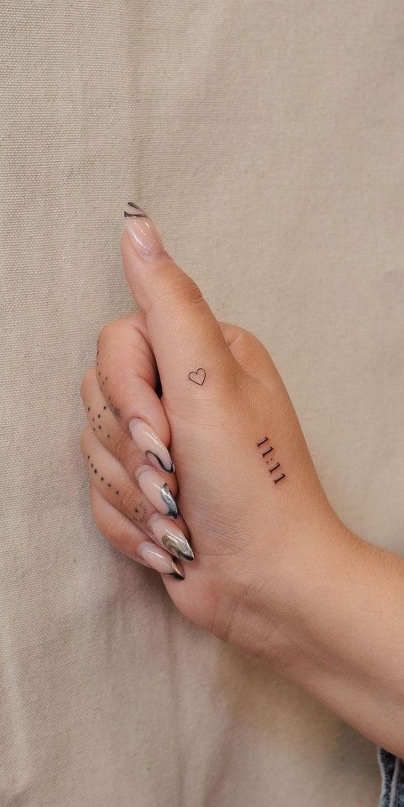 a woman's hand with tattoos on it and the word i love you written in cursive writing