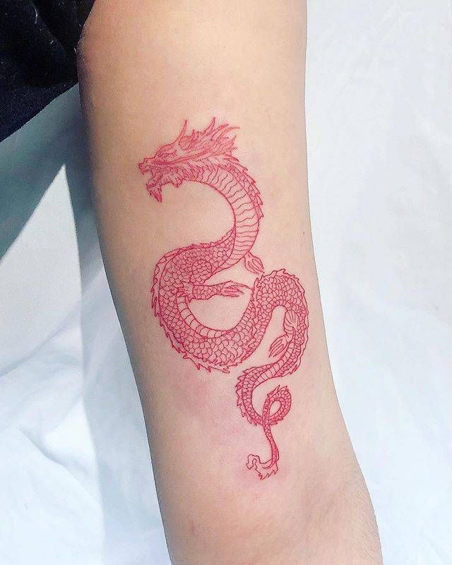 a red dragon tattoo on the arm