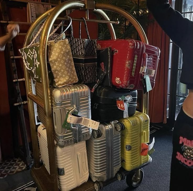 several suitcases are stacked on top of each other in a cart at the airport