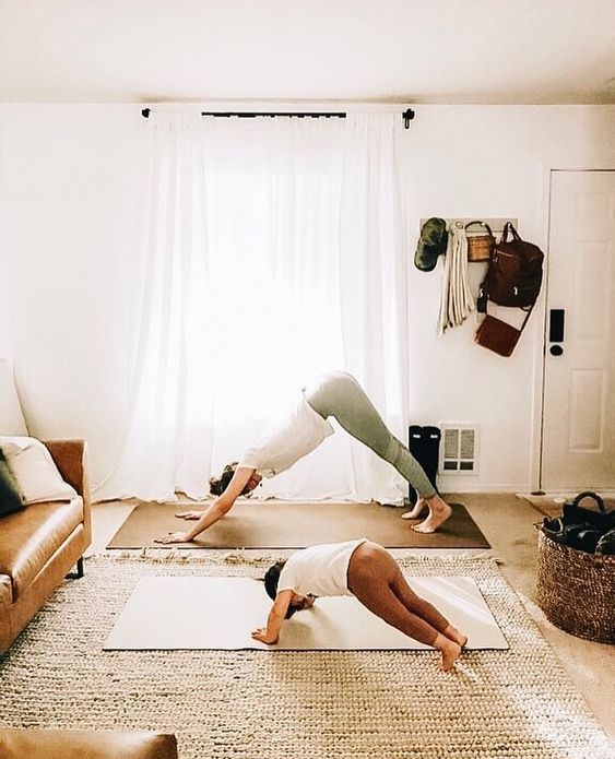 two people doing yoga on their stomachs in front of a window with the caption