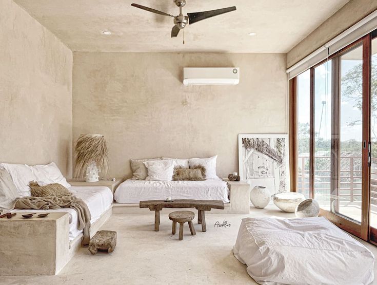 a living room filled with furniture and a ceiling fan