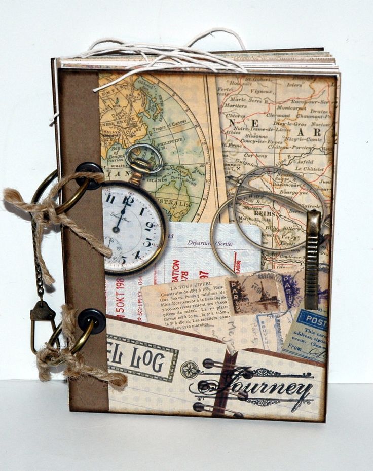 an altered book with old maps, keys and other things attached to the front cover