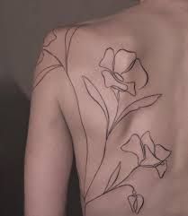 the back of a man with flowers on his chest and shoulder tattoo design in black ink