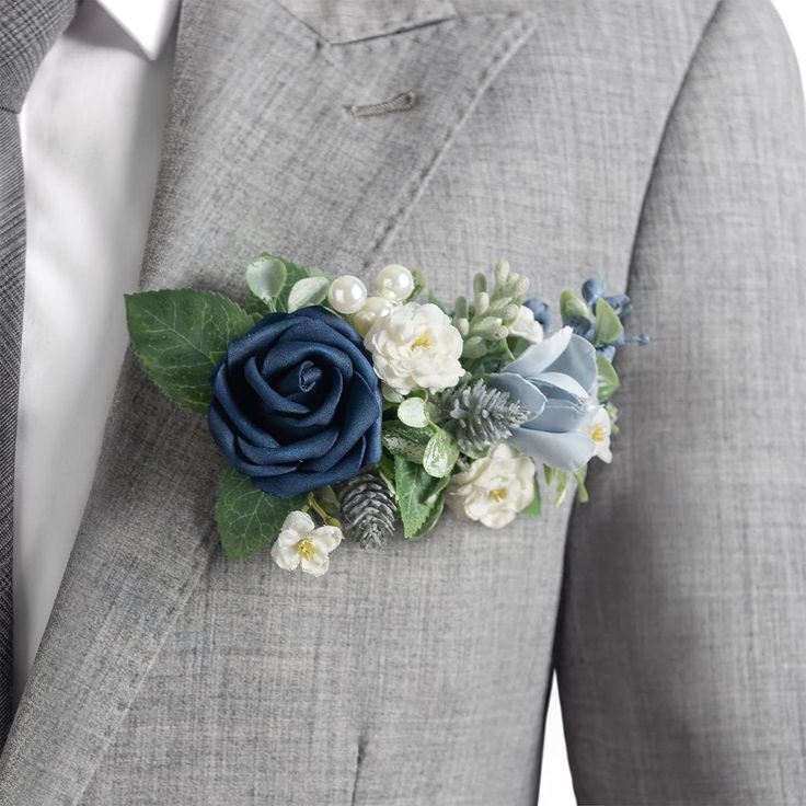 a man in a suit with a boutonniere made out of flowers and leaves