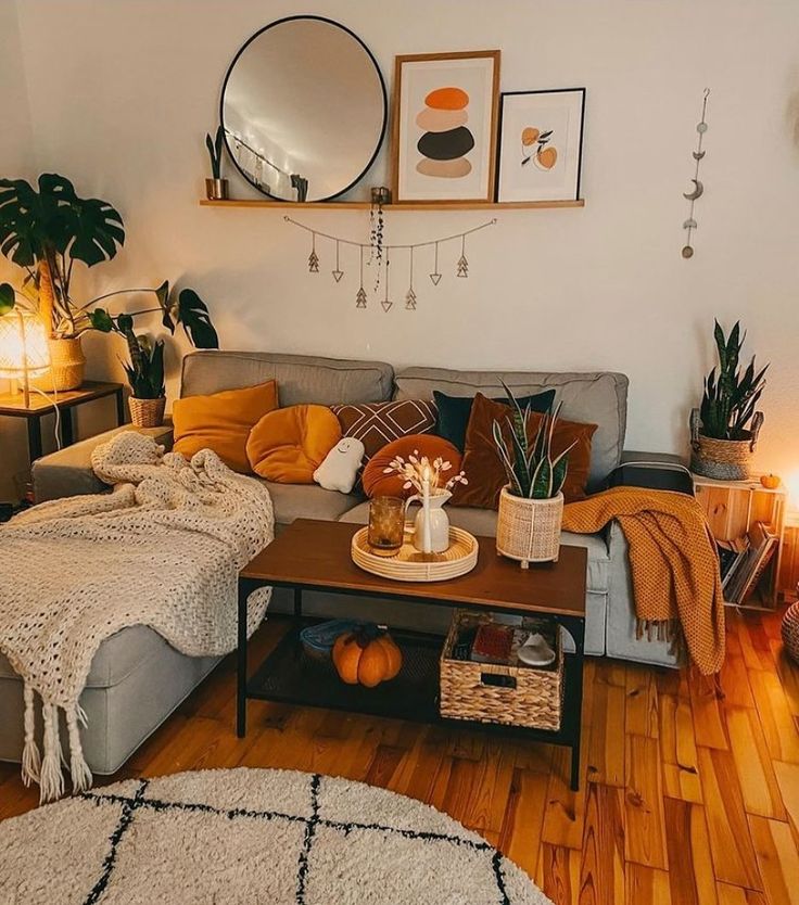 a living room filled with lots of furniture and decor on top of a hard wood floor