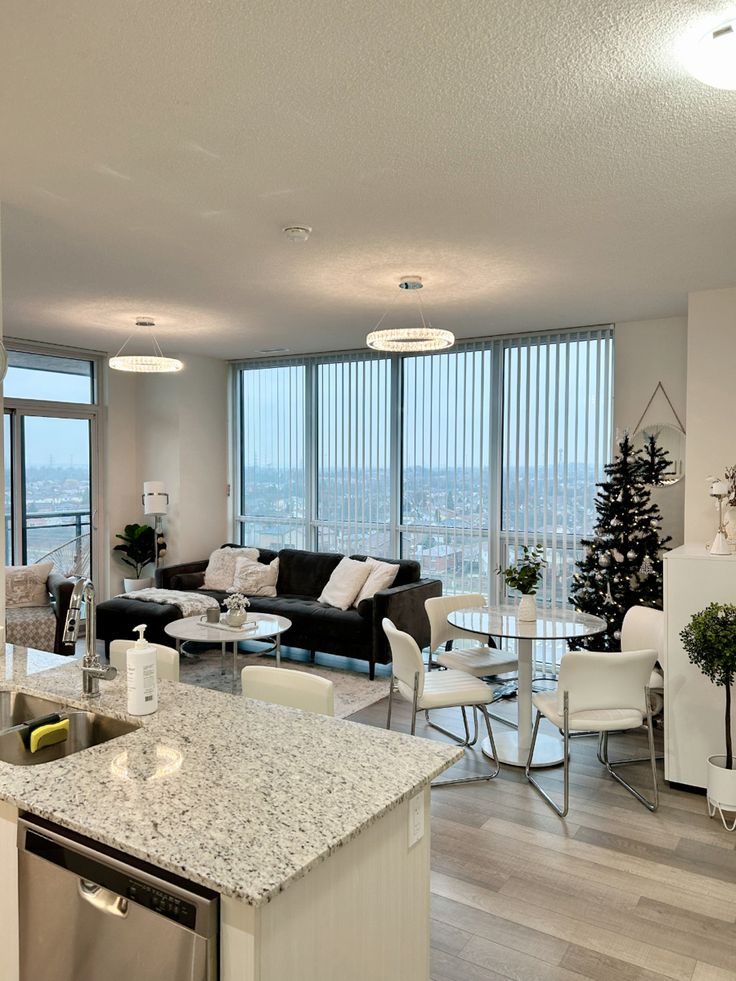 a living room filled with furniture and a large window