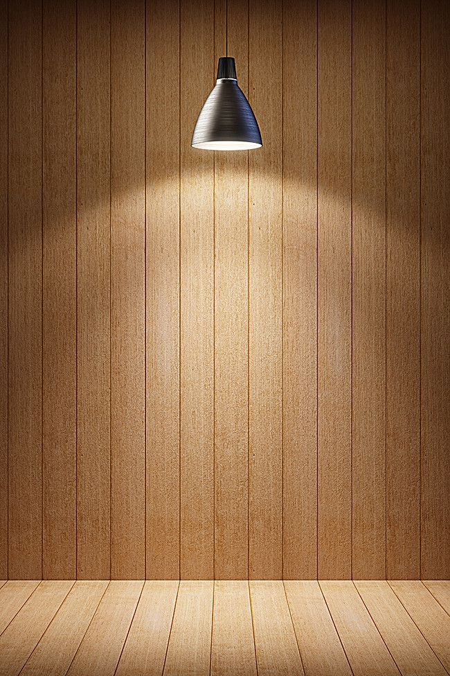 an empty wooden room with a lamp on the wall and wood paneled walls behind it