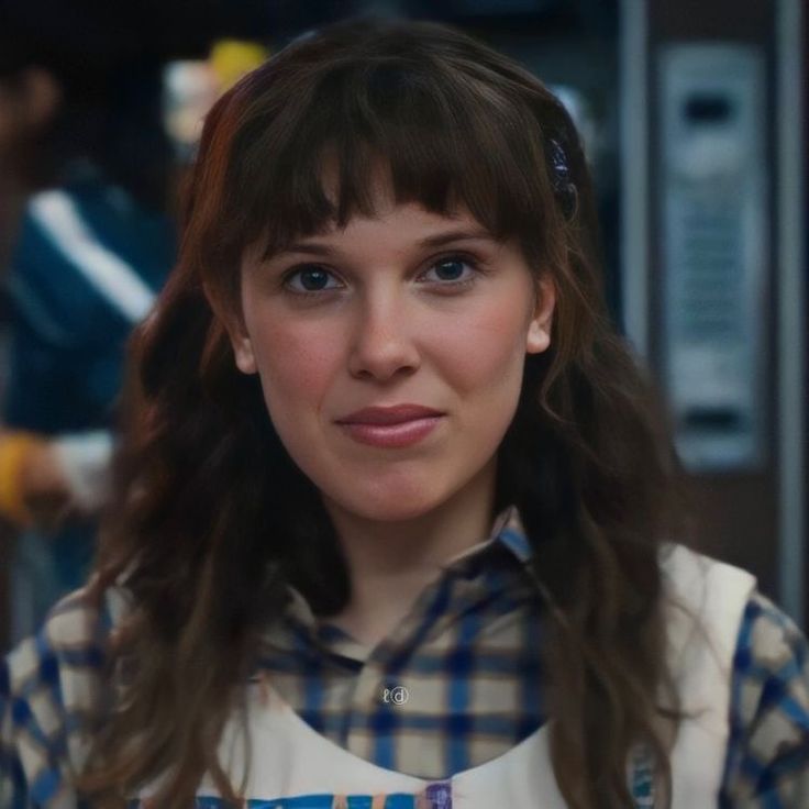 a woman with long hair wearing an apron