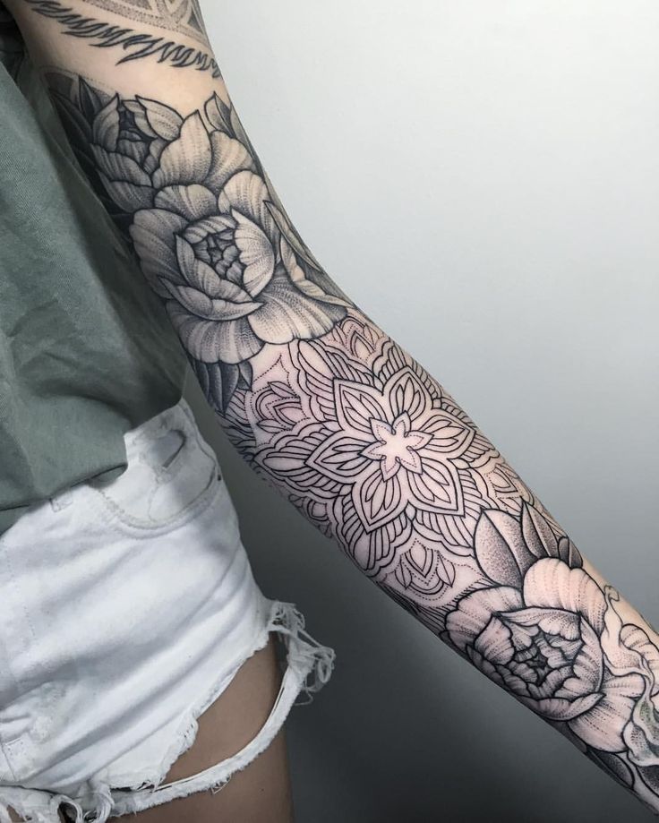 a woman's arm with flowers on it