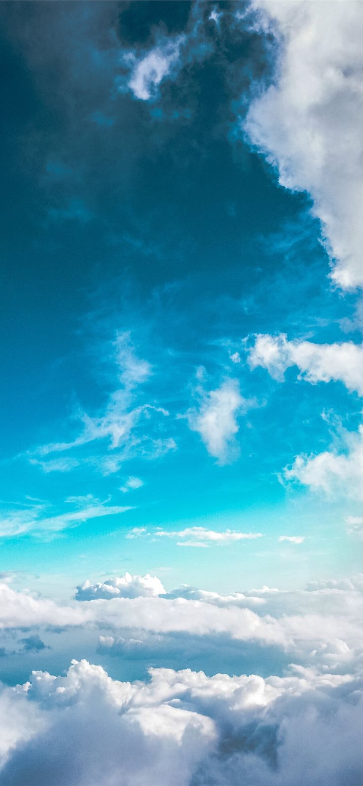 an airplane is flying high above the clouds