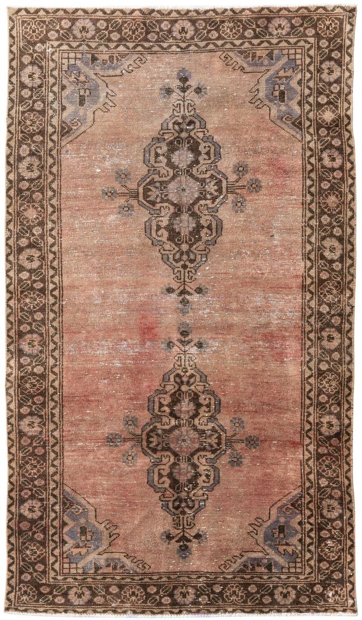 an antique persian rug with brown and beige colors