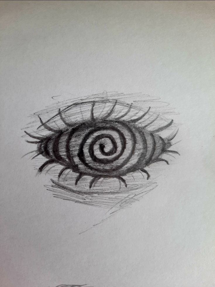 a drawing of an eyeball in the middle of a white sheet with black ink