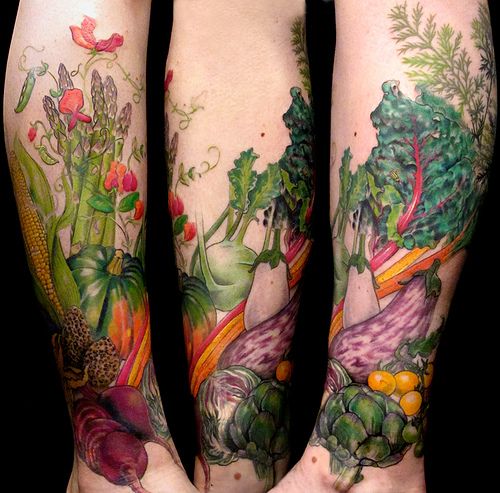 the legs are covered with tattoos and vegetables