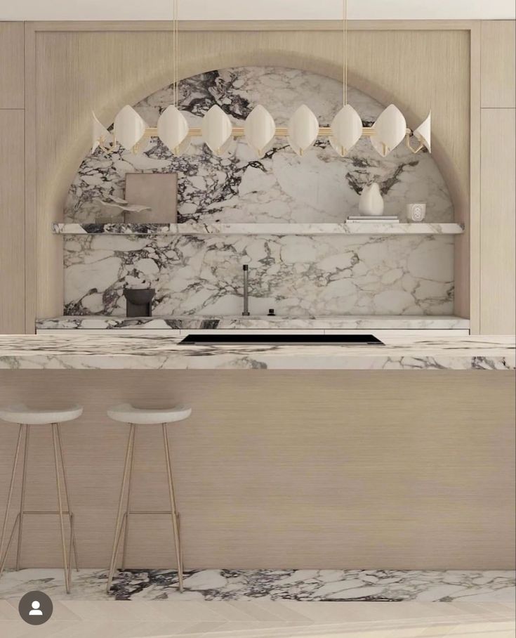 a kitchen with marble counter tops and stools in front of the sink, along with three bar stools