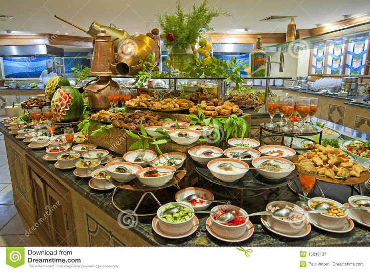 a buffet table filled with lots of different types of food and drinks on it's sides