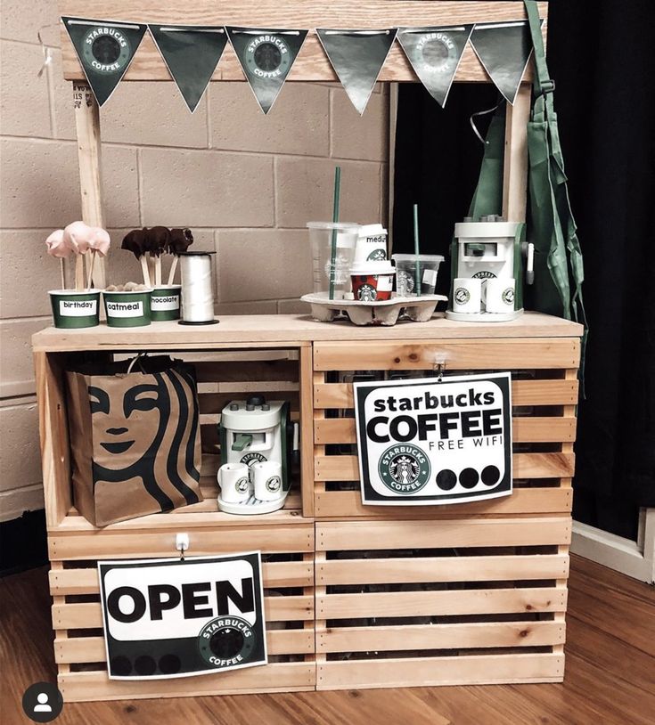 a starbucks coffee stand with signs on it