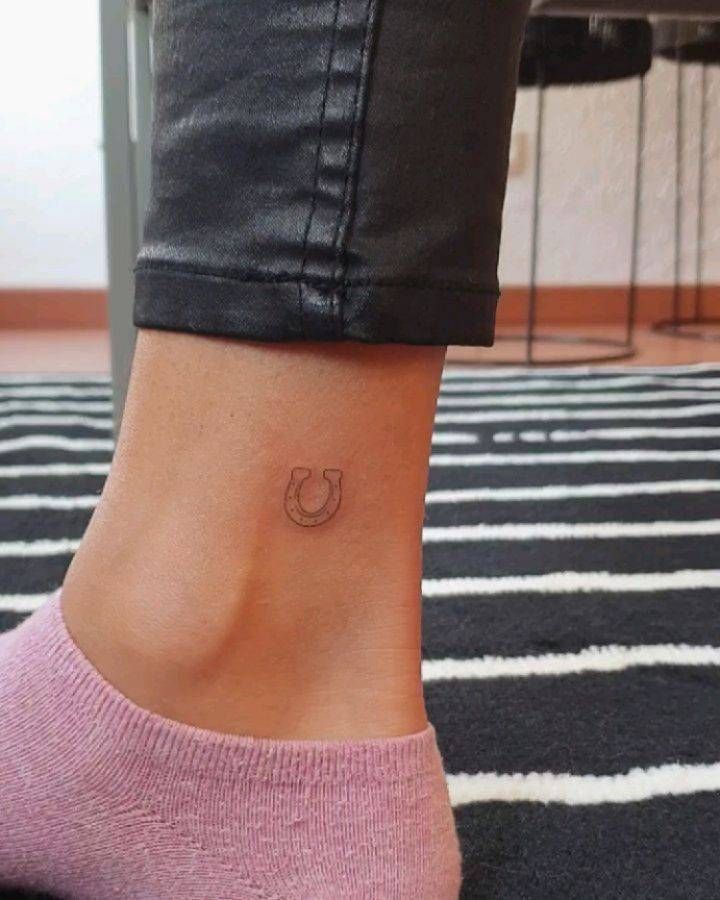 a woman's foot with a small tattoo on the side of her left ankle