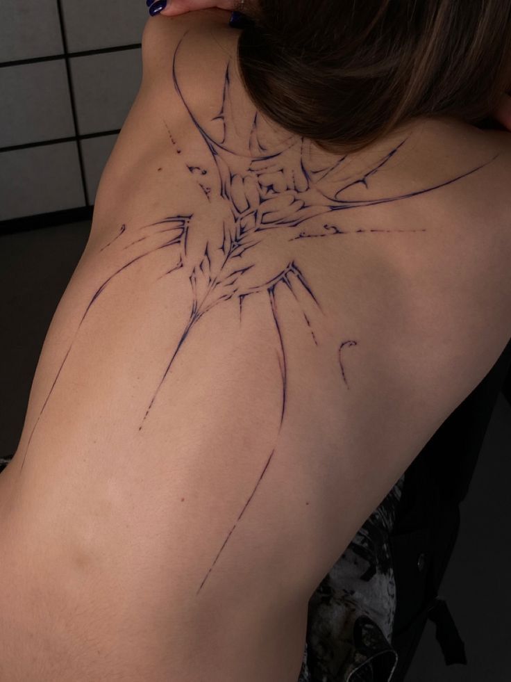 the back of a woman's shoulder with lines drawn on it and an arrow in the center