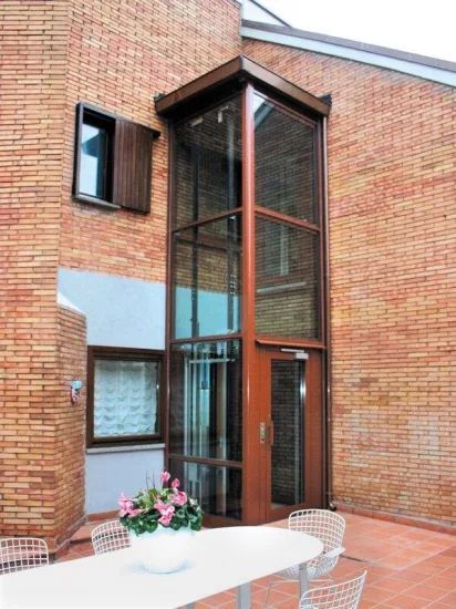 a white table and chairs sitting in front of a brick building with an open door