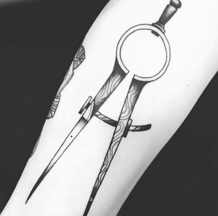 a black and white photo of a tattoo with scissors