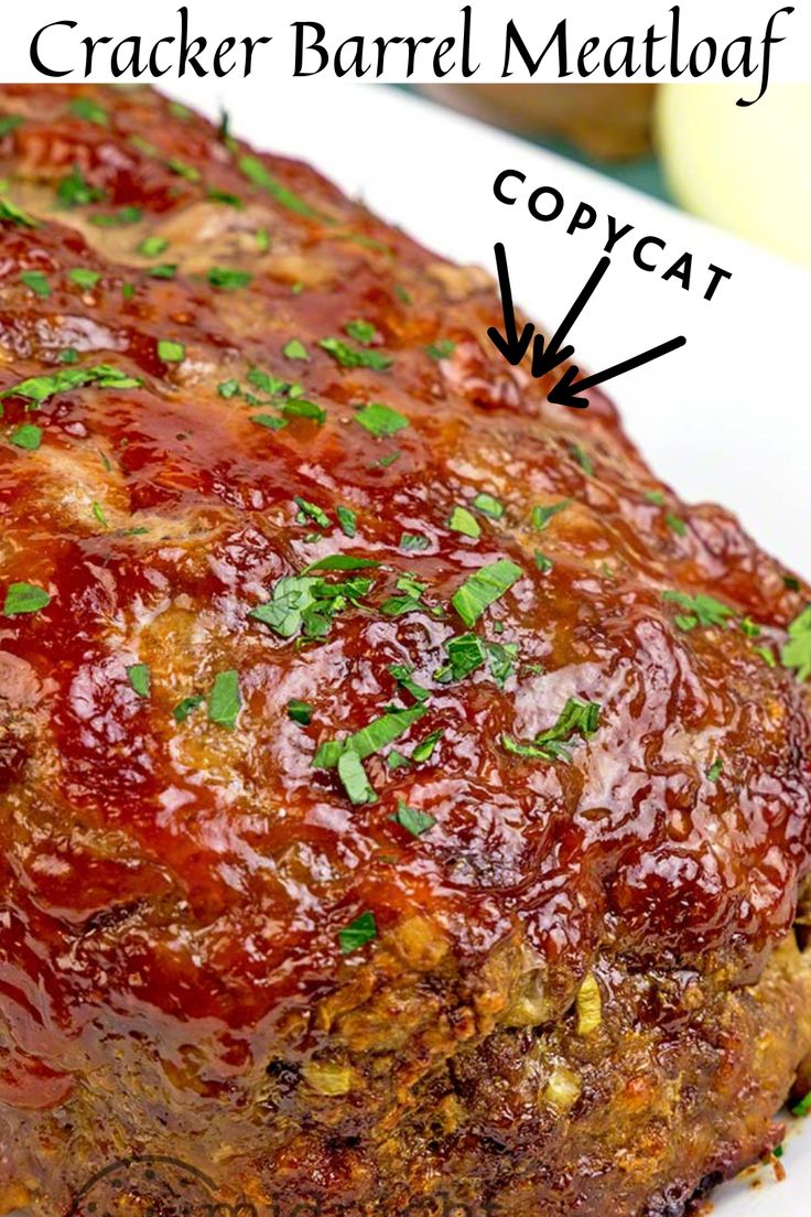 a meatloaf covered in sauce and garnished with parsley