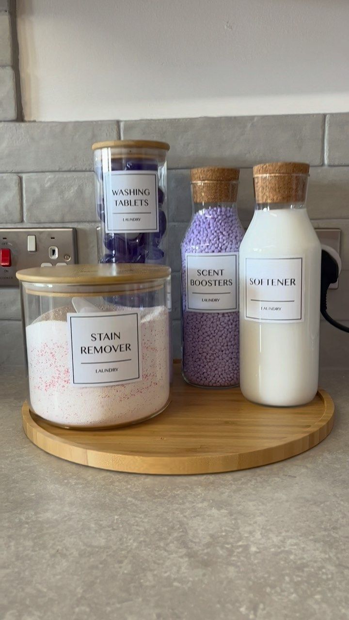 three different types of bath salts on a wooden tray in front of a stove top