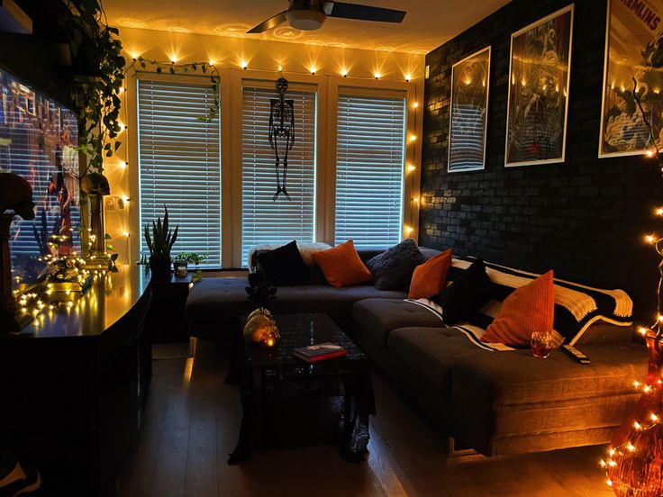 a living room filled with lots of furniture and christmas lights on the windows sill