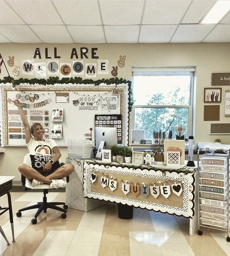 a woman sitting in front of a desk with lots of decorations on top of it