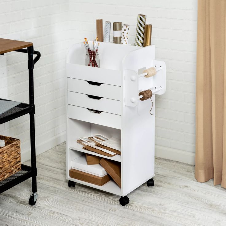 a white desk with drawers and some items on it