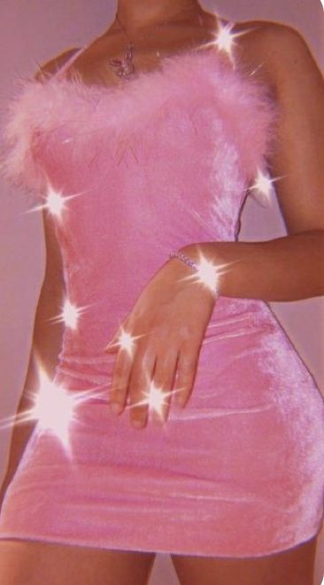 a woman in a pink dress with stars on her chest and hands behind her back