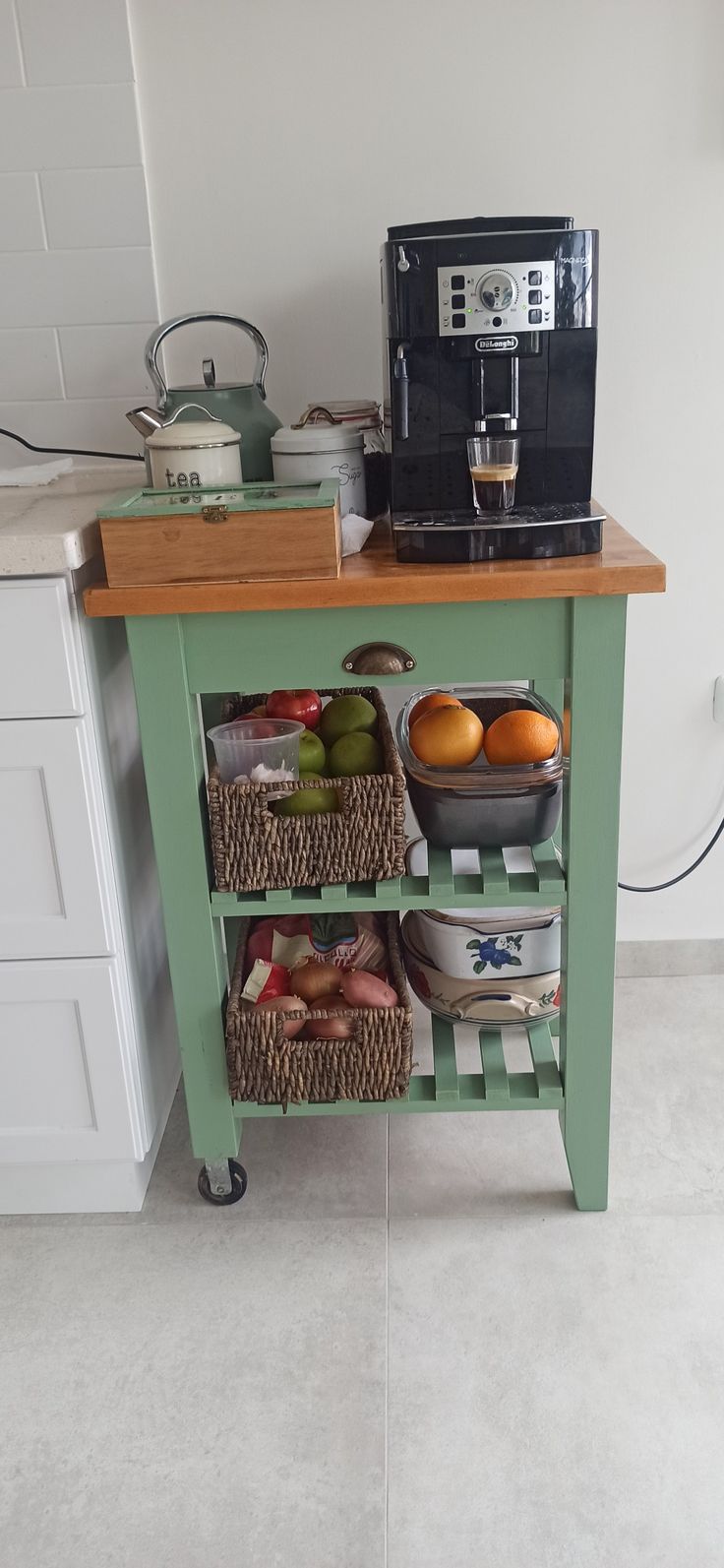 a kitchen island with baskets on it and a coffee maker in the corner behind it