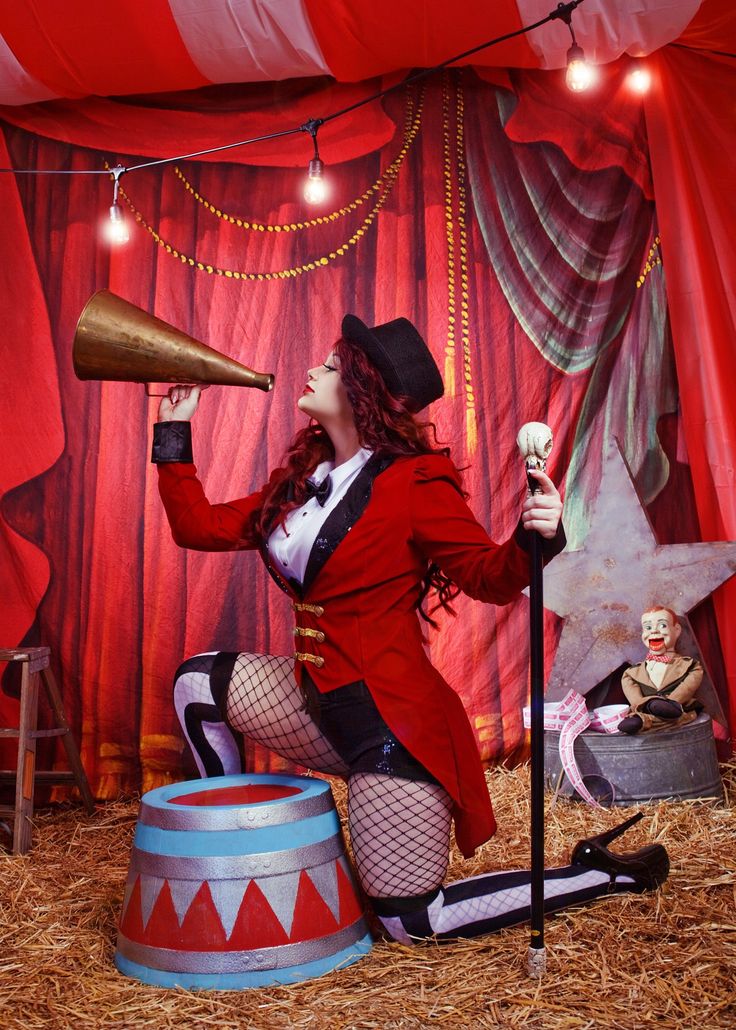 a woman in a circus outfit holding a megaphone