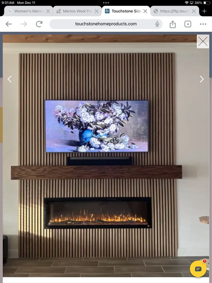 a flat screen tv mounted to the side of a wall next to a fire place