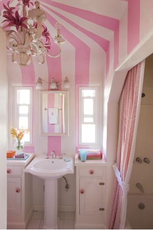 a bathroom with pink and white striped walls